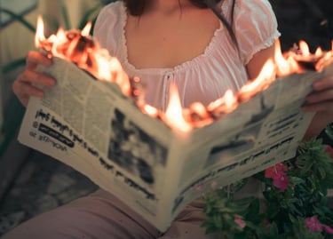 Newspaper with flames coming from the pages