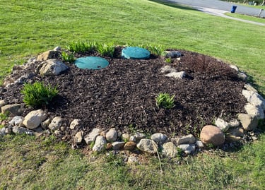 Expert mulch installation and stone edging around septic covers—custom lawn care solutions in Appleton
