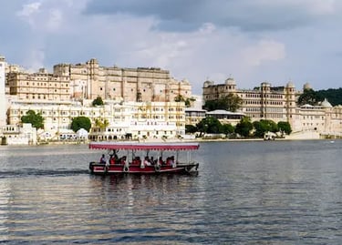 Boat ride on Lake Pichhola with City Palace Udaipur in the background.