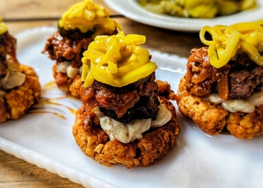 Spicy Garbage Plate-inspired tater tot cups topped with burger, meat sauce, macaroni salad, mustard