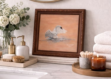 Framed swan oil painting on a marble bathroom vanity with spa decor and a lit candle.
