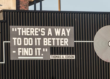 a sign that says "there's a way to do it better" a quote from Thomas A. Edison