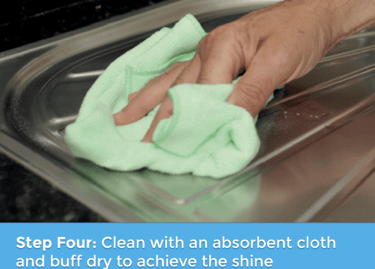 a person cleaning a sink with a cloth cloth