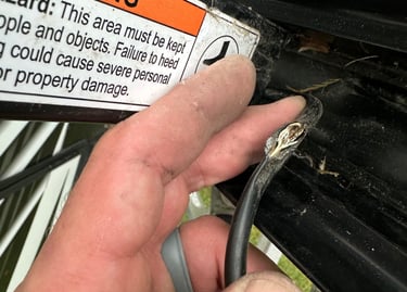 a person holding a piece of metal wire with a cut