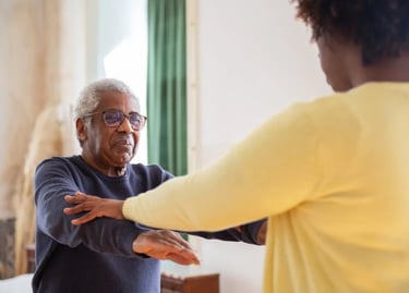 An older man and woman are joyfully dancing together, showcasing their connection and enjoyment of t