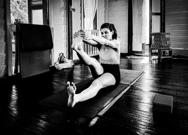 person stretching hamstrings in a gentle yoga pose