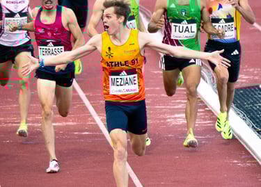 a group of men running in a race track