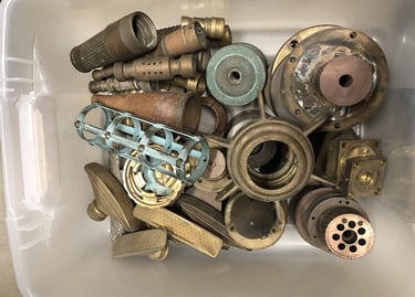 Metal parts in a sculptor's workshop bin, image 15.