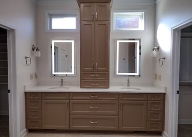Modern master bathroom double vanity with taupe cabinets, marble countertops, and LED lighted mirrors.