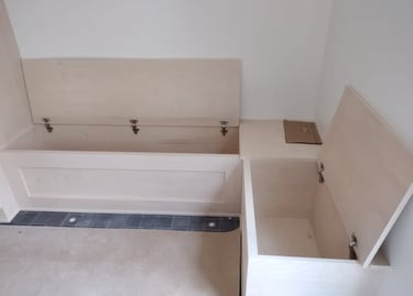 Custom wooden corner storage bench with flip-top lids for entryway organization.