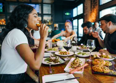 enjoying a delicious meal in a fancy restaurant, sharing with friends 