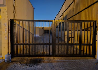 Heavy-duty industrial mild steel swing gate for warehouse entrance in Sharjah.
