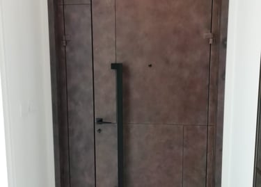 Bespoke wood-effect metal security door for luxury residential villa in Dubai.