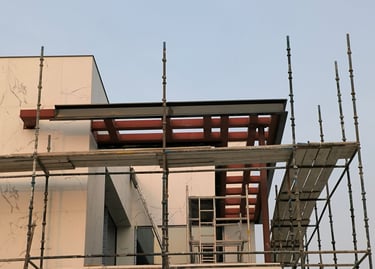 Modern villa entrance canopy with structural steel frame and sleek ACP facade cladding.