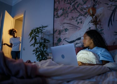A single mother working on a side hustle while kids sleep.