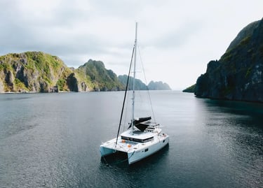 Private luxury yacht cruising through Bacuit Bay, El Nido.