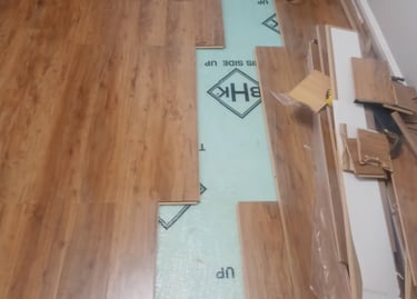 A room in the process of installing hardwood flooring.