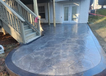 A deck with outdoor furniture and a patio area.