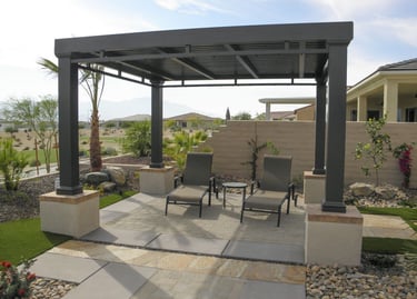 A patio cover with two chairs underneath