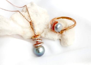 a necklace with a pearl and a ring