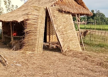 a thatched roof that is sitting on the ground