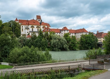 The High Castle of Fussen and St. Mang's Abbey overlooking the Lech River in Germany.