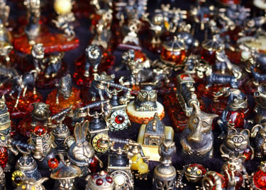 Collection of small bronze animal figurines and vintage ornaments with amber stone details.