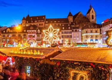 A festive European Christmas market at night with glowing star decorations and snowy stalls.
