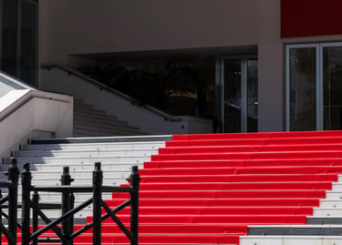 Iconic red carpet stairs at the Palais des Festivals in Cannes for a film festival premiere event.
