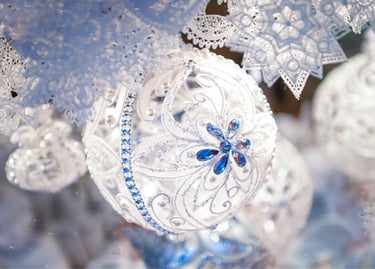 Elegant white glass Christmas ornament with blue crystal floral details and lace snowflakes.