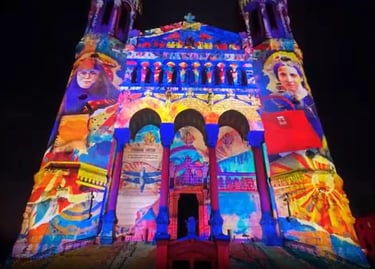 Vibrant light projection mapping on the facade of Lyon's Basilica of Notre-Dame de Fourvière at night.