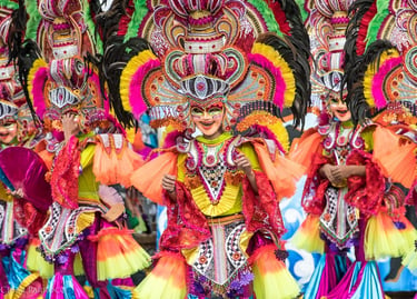 Performers in colorful masks and feathered costumes at the MassKara Festival in Bacolod City.