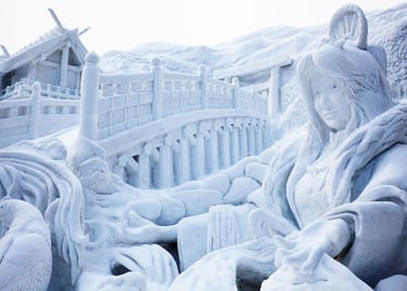 Intricate snow sculpture of a woman and a bridge at the Sapporo Snow Festival in Japan.