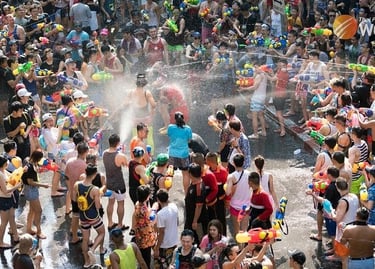 Crowds celebrate Songkran Festival in Thailand with a massive water gun fight on a busy street.