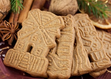 Traditional Dutch speculoos spiced cookies with windmill shapes, star anise, and cinnamon sticks.