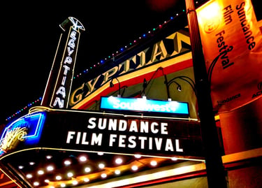 Illuminated Egyptian Theatre marquee hosting the Sundance Film Festival at night in Park City.