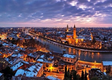 Aerial view of snow-covered Verona, Italy skyline and Adige River at twilight.