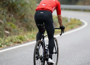 A scenic gravel bike trail winding through the rolling hills of Romagna under a clear blue sky