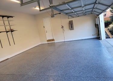 a garage with a garage door open and a garage door open