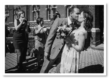 Groom kissing bride during a send off.