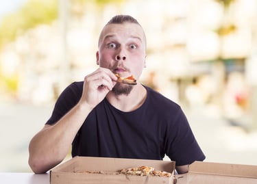 a man eating pizza
