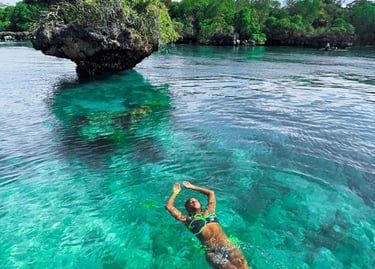 Tourist swimming in crystal-clear waters during Safari Blue Zanzibar boat tour, enjoying snorkeling and marine life adventure
