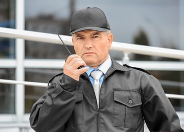 Guardia de seguridad observando y reportando incidente por medio de su Radio PoC