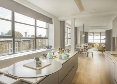 a kitchen with a large window and a table with a phone