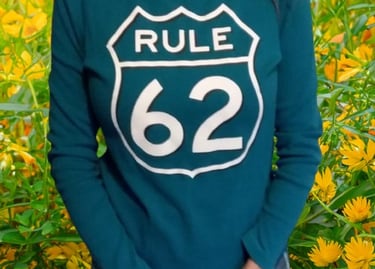 a woman in a green shirt Rule 62 on it