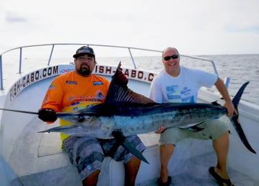 two men are holding a fish on a boat