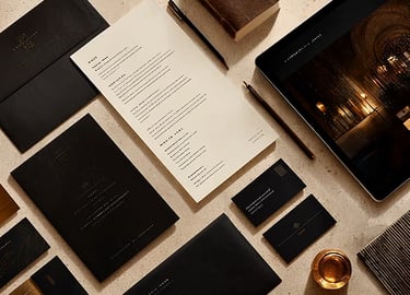 An assembly of brand assets live flyers, business cards and others carefully laid out on a table.