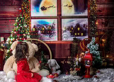 a little girl in a red dress sitting on a rug