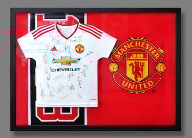 A jersey frame featuring team-signed Manchester United Jersey set against their team flag.