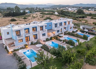 Luxury blue and white holiday villas in Greece with private pools and scenic mountain views.